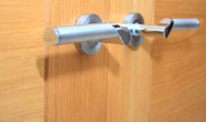 Second-fix carpentry silver handles on an oak door.